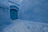 Blue door between blue walls in the blue city of Chefchaouen, Morocco