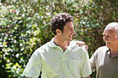 Caucasian father and son walking in park, Cape Town, Western Cape, South Africa