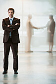 Businessman standing with arms crossed in office, Cape Town, Western Cape, South Africa