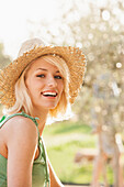 Woman wearing straw hat outdoors, Palma de Mallorca, Balearic Islands, Spain