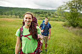 Caucasian couple hiking in rural field, Charlottesville, Virginia, USA