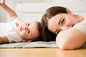 Mother and baby playing in living room, Jersey City, New Jersey, USA