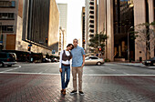 Couple standing on city street, Los Angeles, CA, USA
