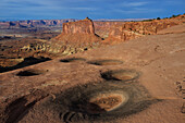 POT HOLES IN SANDSTONE AND GREEN RIVER CANYON, CANYONLANDS NATIONAL PARK, UTAH, USA