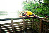 Woman practicing yoga in the forest, Landes, Hossegor