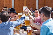 Germany, Bavaria, Munich, Oktoberfest, Group of People Holding Beer Mugs