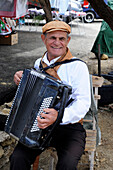 Man playing the accordion in Gozo island, a small island of the Maltese archipelago in the Mediterranean Sea, Europe