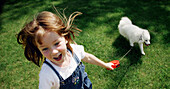 Little Girl Playing With Her Dog