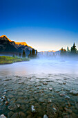 Sunrise And Early Morning Mist On Mountain River