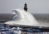 'Sunderland, Tyne And Wear, England; Waves Crashing Into A Pier And Lighthouse'