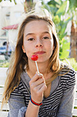 'A Girl Holding A Lollipop; Tarifa, Cadiz, Andalusia, Spain'