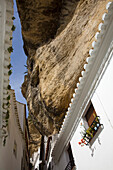 'Setenil De Las Bodegas, Andalusia, Spain; White Houses Along The Street Underneath A Rock Cliff'