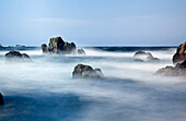 'Mist Surrounding Big Rocks In The Water; Northumberland, England'