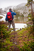 'A Man Hiking Through The Mountains; Fernie, British Columbia, Canada'