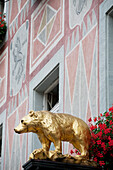 'Gold Bear Sculpture With Flowers And A Painted Building; Freiburg, Germany'