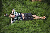 'A Boy Lays Down On The Green Grass; Houten, The Netherlands'