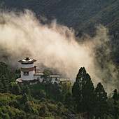 'Smoke Rising Up A Mountainside To A Building; Trongsa District Bhutan'