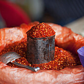'Chili Powder In A Container With A Scoop At A Market; Thimphu Thimphu District Bhutan'