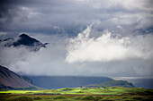 'The Peak Of A Mountain Seen Through Low Lying Clouds; Iceland'