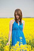 A Young Girl In A Canola Field