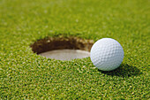 Golf Ball Near A Hole