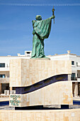 'Green Statue Of A Male Figure Holding A Cross; Lagos Algarve, Portugal'