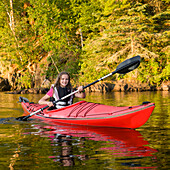 'A Girl Kayaking In The Lake; Lake Of The Woods, Ontario, Canada'