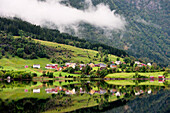 'Houses In A Valley Along The Water With Low Cloud; Granvin, Norway'