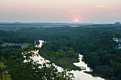 'Sunset over a forest and mountainous landscape;Hollister missouri united states of america'