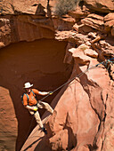 'Man rappelling into a canyon;San rafael swell utah united states of america'