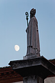 'Silhouetted statue of a bishop with the moon in the sky;Ravenna emilia-romagna italy'