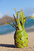 'A pineapple made of braided palm leaves;Waikiki oahu hawaii united states of america'