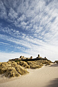 'Bamburgh Castle viewed from the beach; Bamburgh, Northumberland, England'