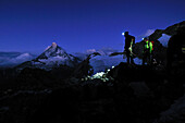 Start in the night: mountaineers on the Arbengrat of Obergabelhorn (4034 m), Wallis, Switzerland
