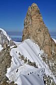 Mountaineers on a cornice at Arete Rochefort, Dent du Geant in the background, Mont Blanc Group, France