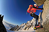 Mountaineer climbing with crampons on granite, Tour Ronde at Mont Maudit, Mont Blanc Group, France