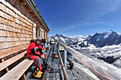 mountaineers on the balcony of Mitteleggi Hütte, Eiger (3970 m), Bernese Alps, Switzerland