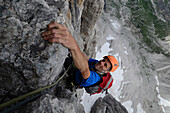 Climber in the eleventh pitch of Via del Guide, Northeast Face of Crozzon di Brenta, Trentino, Italy