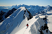 Mountaineer on the ridge between Morgenhorn und Wisse Frau, Blümlisalp (3661 m), Bernese Alps, Switzerland