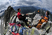 Two mountaineers at the summit of Grundschartner, Zillertaler Alpen, Tirol, Austria