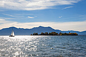 Sailboat, view over Chiemsee to Fraueninsel, near Gstadt, Chiemsee, Chiemgau region, Bavaria, Germany