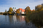 View over the monastery lake to Seeon monastery, Chiemgau region, Bavaria, Germany