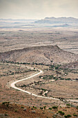 Curvy dirt track road along the outback highlands, Namibia near Windhuk, Africa