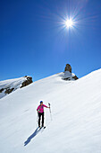 Female back-country skier ascending to Corno d Angolo, Cristallo Group, Dolomites, Veneto, Italy