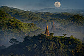 Full moon in Burma, view above hill and pagoda in the morning mist at Mrauk U, Myohaung north of Sittwe, Akyab, Rakhaing State, Arakan, Myanmar, Burma