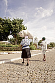 Two women passing a street, Praia, Santiago, Cape Verde