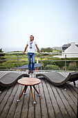 Man on the terrace of hotel room at Hostellerie de la Pointe Saint Mathieu, at the lighthouse in Plougonvelin, Finistere, Pays d'Iroise, Brittany, France