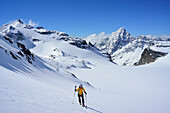 Frau auf Skitour steigt zum Piz Buin auf, Piz Fliana und Piz Linard im Hintergrund, Silvretta, Unterengadin, Engadin, Kanton Graubünden, Schweiz