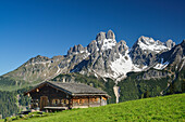 Alpine hut with mount Bischofsmuetze in background, Sulzenalm, Dachstein Mountains, Salzburg, Austria