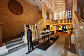 Page boy Fabian Enrique Flores Islas welcoming guests in the lobby of Das Stue Hotel, Drakestrasse 1, Tiergarten, Berlin, Germany